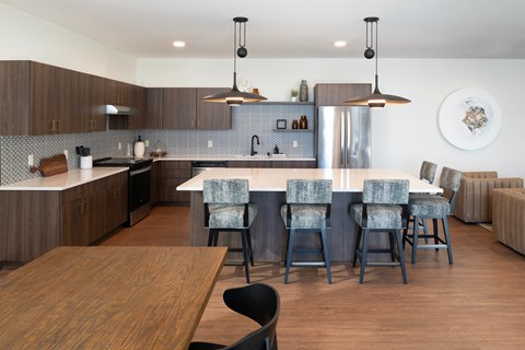 A modern kitchen with a dining table and chairs.