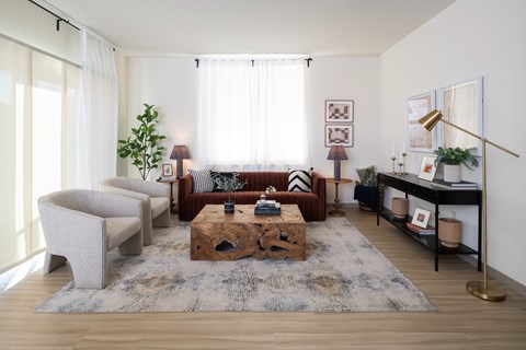 A living room with a wooden coffee table and a grey sofa.