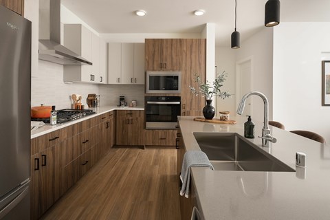 A modern kitchen with wooden cabinets and stainless steel appliances.