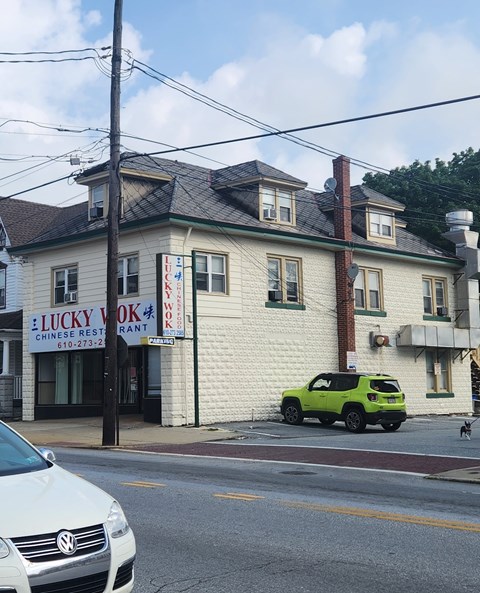 A white building with a sign that says Lucky Yok on it.