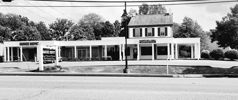 A black and white photo of a building with a sign that says "Bank of America".