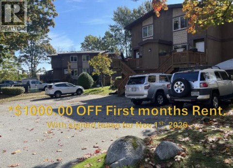 A real estate sign advertises $1000 off the first month's rent with a lease starting on November 1st, 2026.