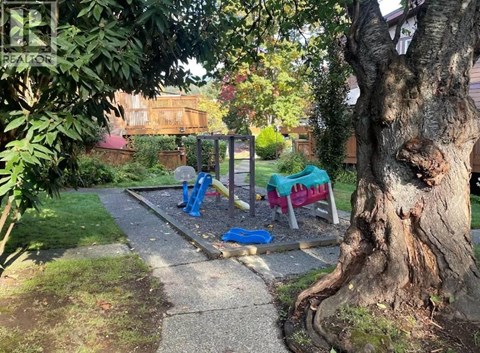A playground with a slide and swings in a park.