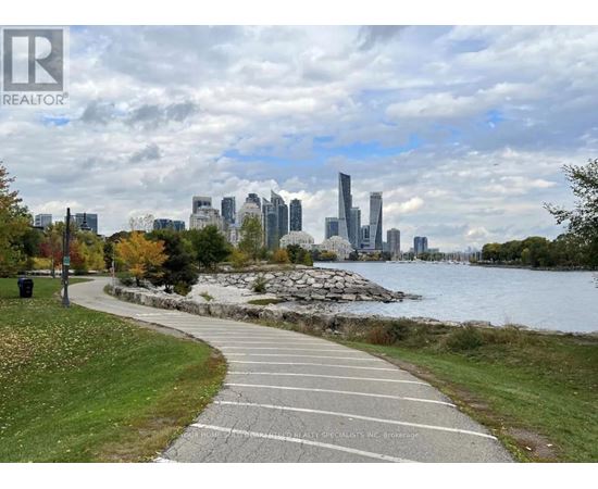 A city skyline is visible in the distance behind a walkway.