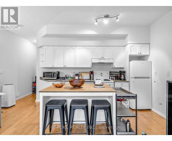 A white kitchen with a table and chairs.