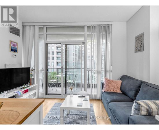 A living room with a grey couch and a flat screen TV.