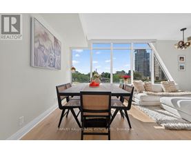 A dining room with a table set for two and a view of the city.