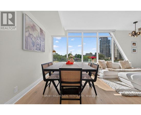 A dining room with a table set for two and a view of the city.