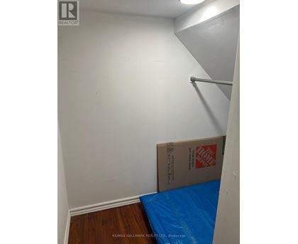 A room with a white wall and a blue tarp on the floor.