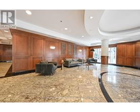A spacious living room with wooden paneling and a marble floor.
