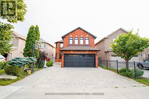 A house with a brick facade and a black garage door is for sale.