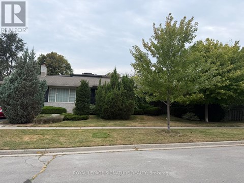 A house with a lawn and trees in front of it.