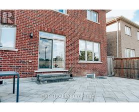 A red brick house with a glass door and windows.