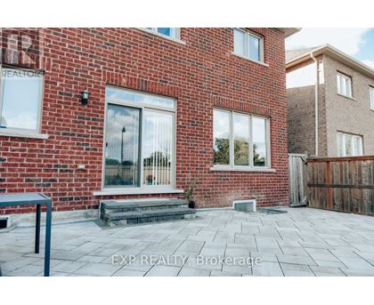 A red brick house with a glass door and windows.
