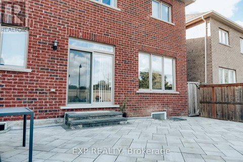 A red brick house with a glass door and windows.