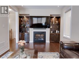 A living room with a fireplace and a vase of flowers on the coffee table.