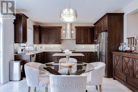 A modern kitchen with dark wood cabinets and a glass table with four chairs.