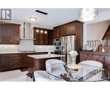 A modern kitchen with dark wood cabinets and white countertops.