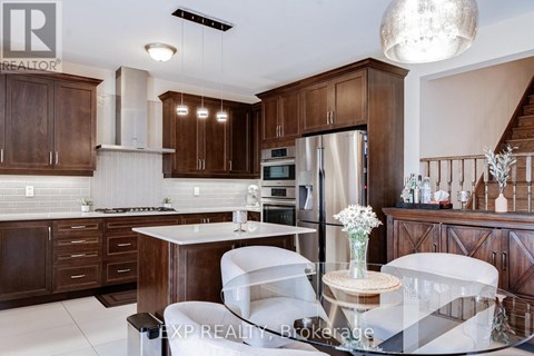 A modern kitchen with dark wood cabinets and white countertops.