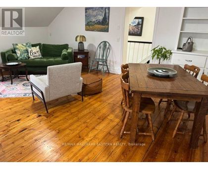A living room with a green couch and a wooden table.