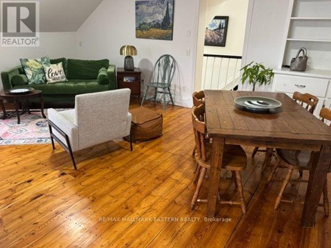 A living room with a green couch and a wooden table.