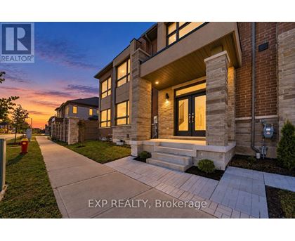 A house with a walkway in front of it at dusk.