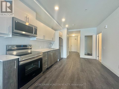 A modern kitchen with stainless steel appliances and wooden cabinets.