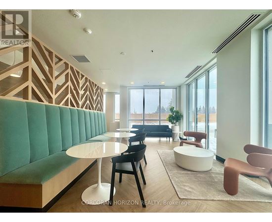 A modern living room with a green sofa and wooden accents.