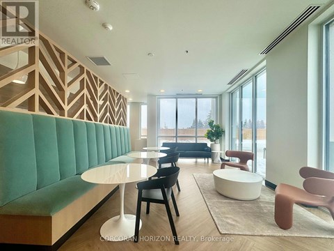 A modern living room with a green sofa and wooden accents.