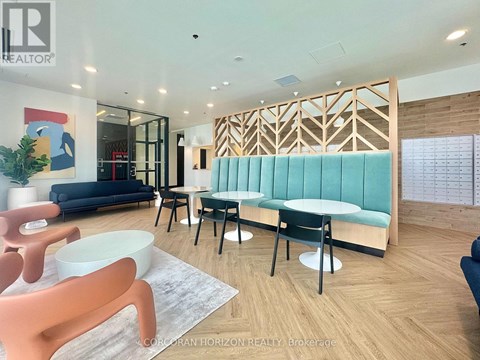A realtor office with a blue couch and a wooden partition.