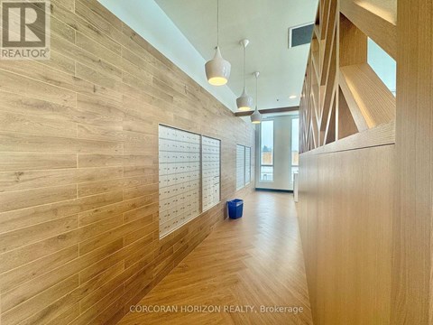 A hallway with wood paneling and a brokerage sign.