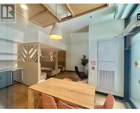 A conference room with a long table and chairs.