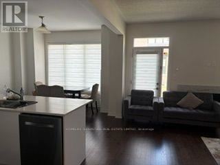 A living room with a grey couch and a wooden table.