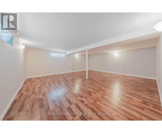 A room with wooden flooring and white walls, likely a bedroom or office space.