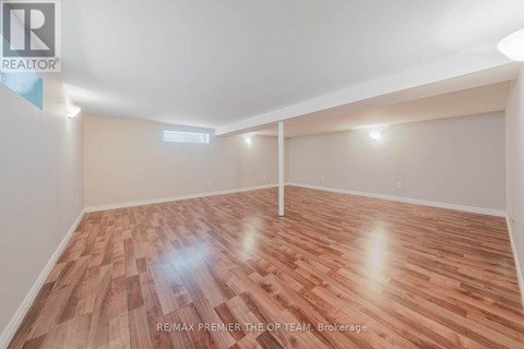 A room with wooden flooring and white walls, likely a bedroom or office space.