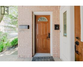 A brown door is in front of a white door.