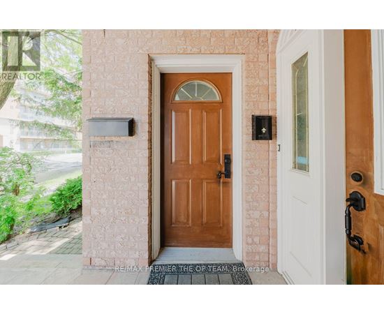 A brown door is in front of a white door.