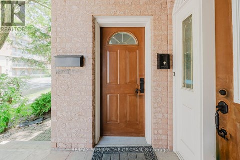 A brown door is in front of a white door.