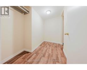 A room with wooden flooring and white walls.