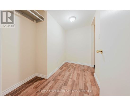 A room with wooden flooring and white walls.
