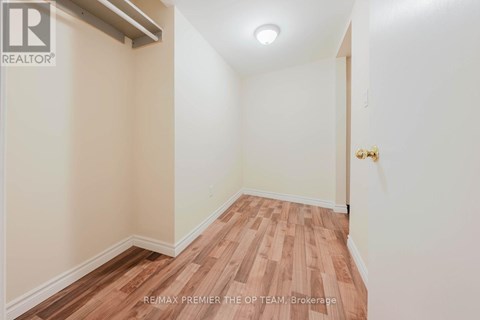 A room with wooden flooring and white walls.