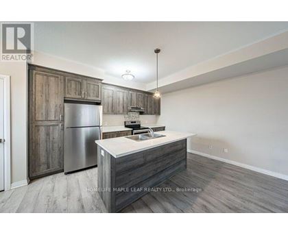 A kitchen with a wooden cabinet and a stainless steel refrigerator.