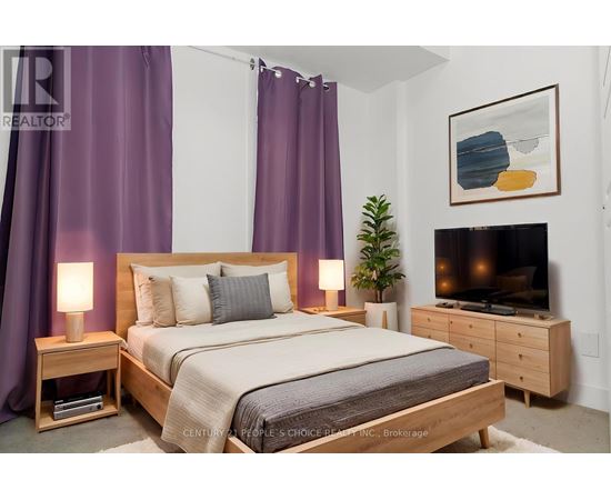 A bedroom with a bed, nightstand, and a television.