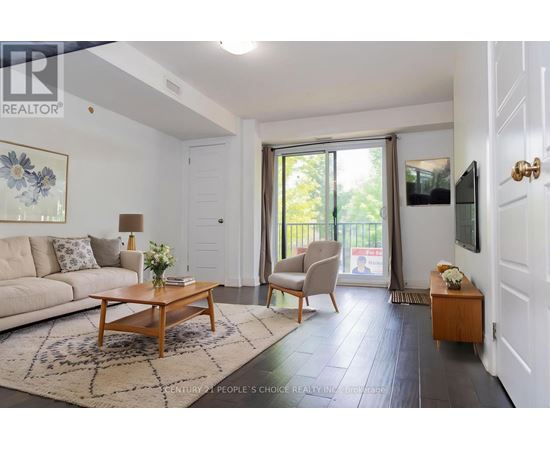 A living room with a sofa, a coffee table, and a chair.