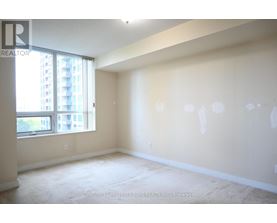A spacious room with a large window and a view of a building outside.