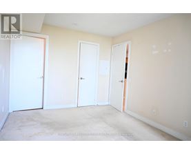 A room with three doors and a carpeted floor.
