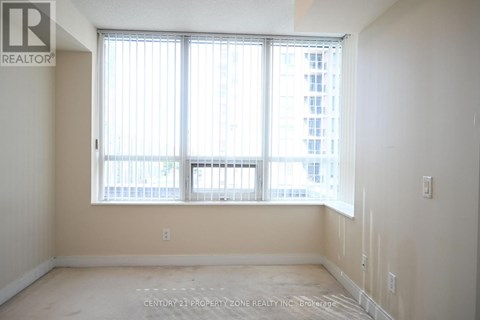 A room with a large window and a view of a building outside.