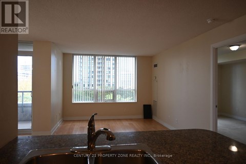 A kitchen with a sink and a window.