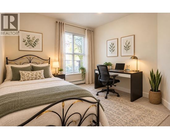 A bedroom with a bed, desk, and chair.