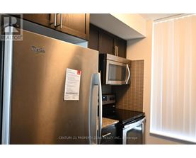 A stainless steel refrigerator with a note attached to it.